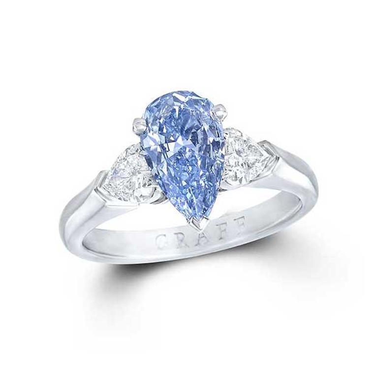 Graff 1.04ct Internally Flawless Fancy Deep blue diamond engagement ring flanked by two pear-shaped white diamonds.